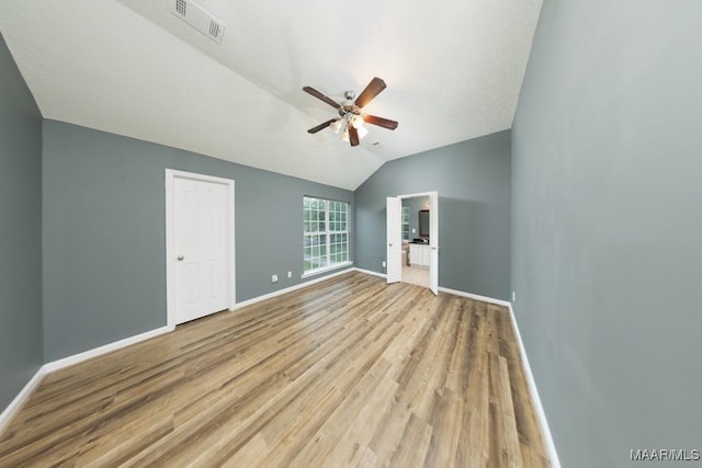 interior space featuring light hardwood / wood-style floors, lofted ceiling, and ceiling fan