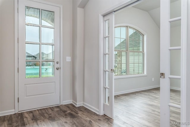 entryway featuring lofted ceiling and hardwood / wood-style flooring