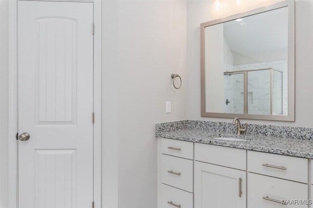 bathroom with vanity and an enclosed shower