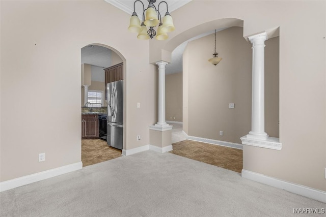 interior space featuring crown molding, sink, light colored carpet, and ornate columns