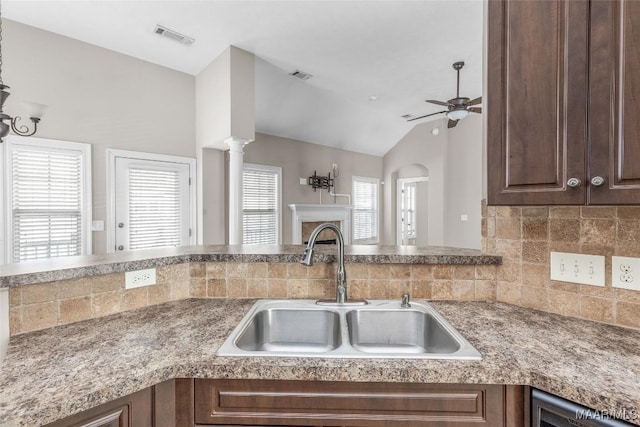 kitchen featuring sink, ceiling fan, lofted ceiling, and tasteful backsplash