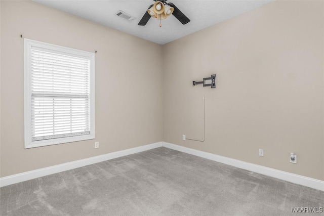 carpeted spare room with ceiling fan