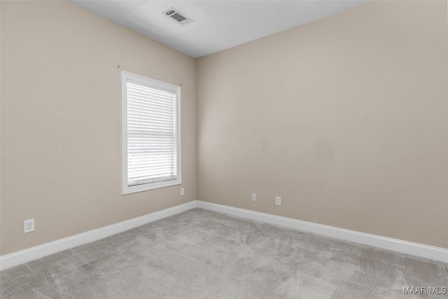 unfurnished room with light colored carpet