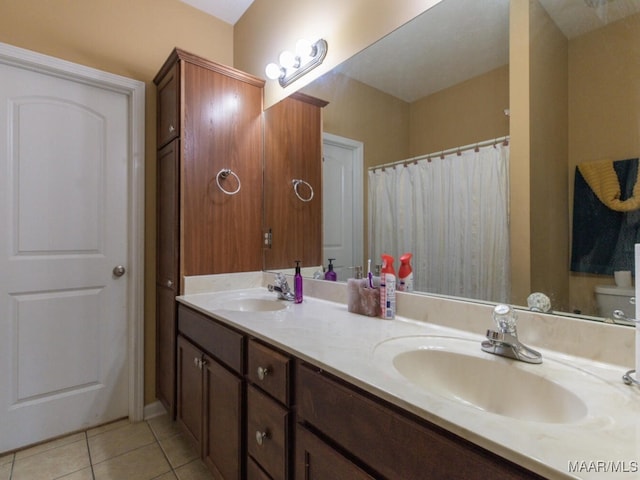 bathroom with toilet, tile patterned floors, and vanity