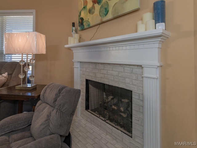 living room with a brick fireplace