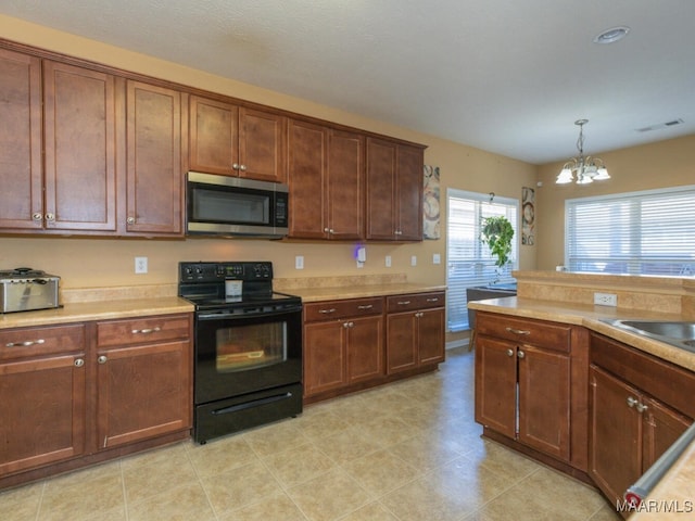 kitchen with sink, hanging light fixtures, black / electric stove, and a notable chandelier