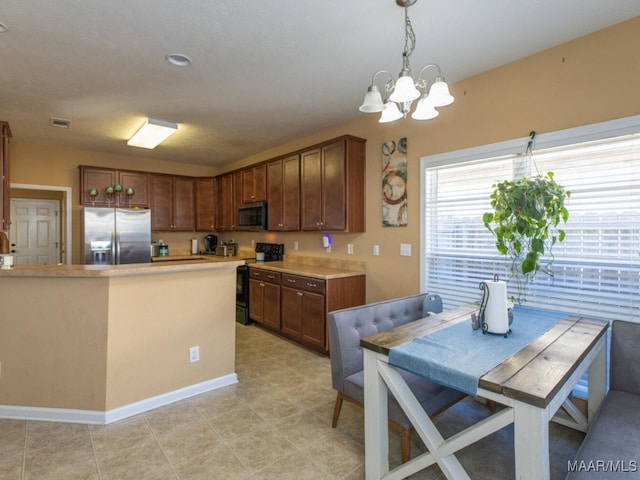 kitchen with hanging light fixtures, appliances with stainless steel finishes, and a notable chandelier