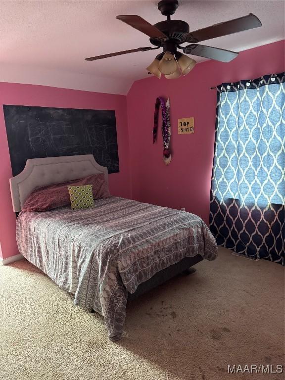 carpeted bedroom featuring vaulted ceiling and ceiling fan