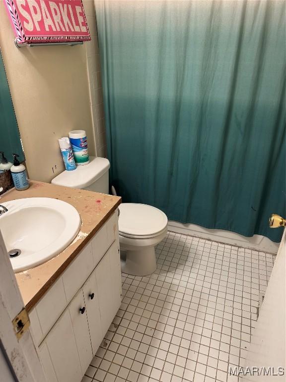 bathroom with vanity, toilet, and tile patterned flooring