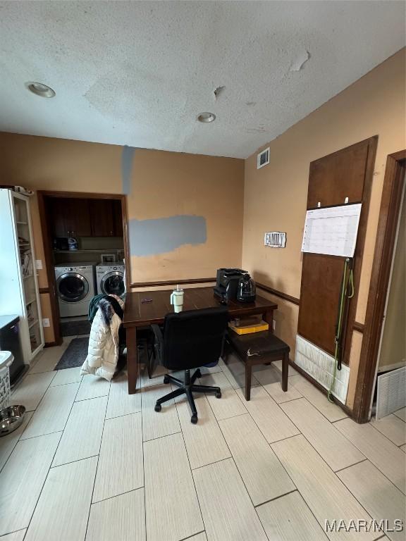 office area featuring a textured ceiling and independent washer and dryer