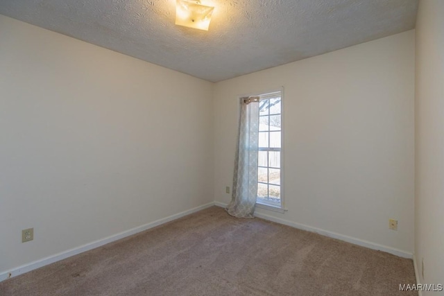 carpeted spare room with a textured ceiling