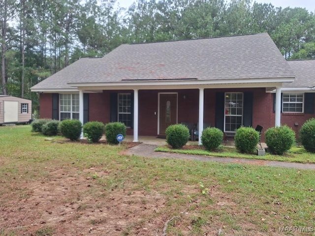 ranch-style house with a porch and a front lawn