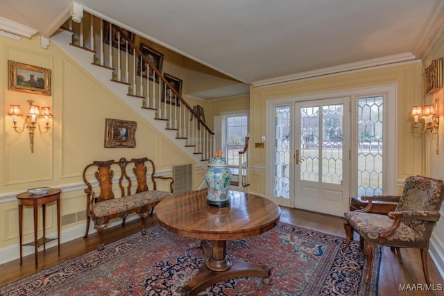 foyer with crown molding and wood-type flooring