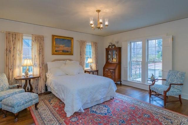 bedroom with wood-type flooring and a notable chandelier