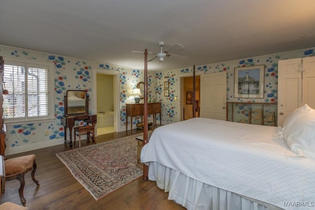 bedroom featuring dark hardwood / wood-style flooring, ceiling fan, and ensuite bathroom