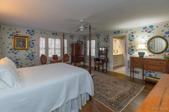 bedroom with connected bathroom, wood-type flooring, and ceiling fan