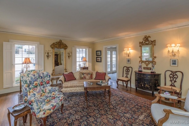 living room with crown molding, wood-type flooring, and a healthy amount of sunlight