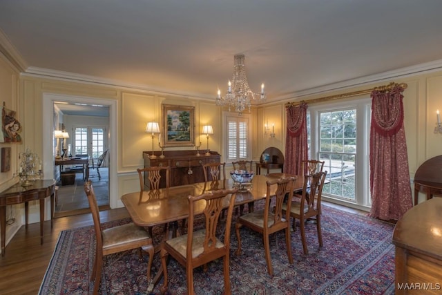 dining room featuring an inviting chandelier, dark hardwood / wood-style flooring, and ornamental molding