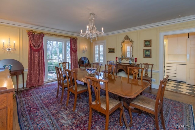 dining space with an inviting chandelier, hardwood / wood-style floors, and ornamental molding