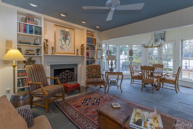 interior space with built in features and ceiling fan