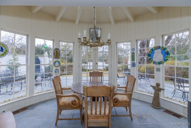 sunroom featuring a chandelier and vaulted ceiling with beams