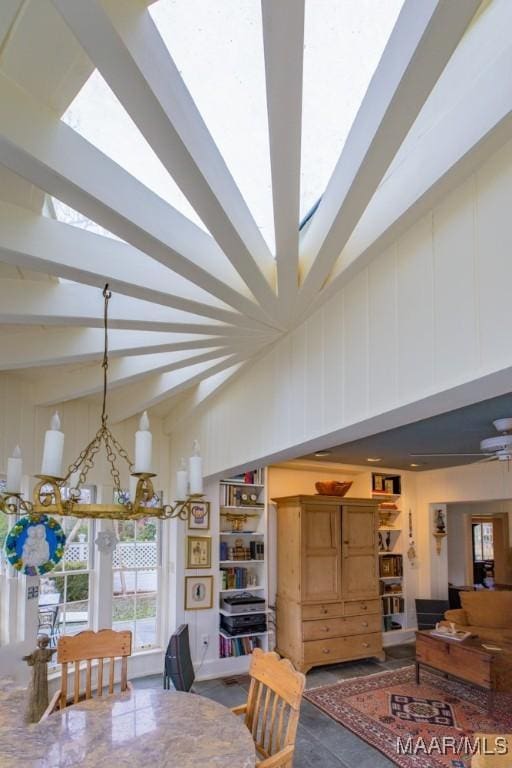 dining area with built in features and a chandelier