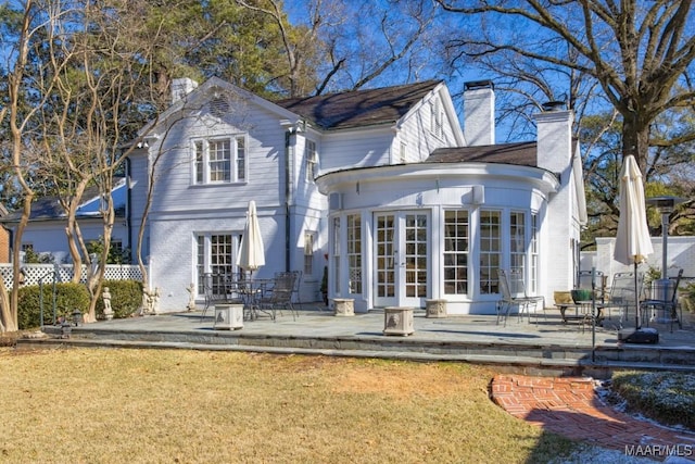 rear view of property with a yard, a patio, and french doors