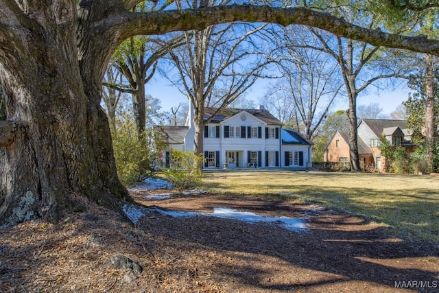 back of house with a lawn