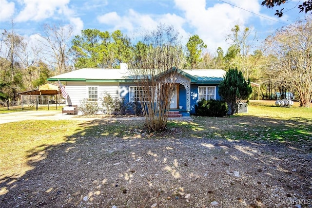 single story home featuring a carport and a front yard