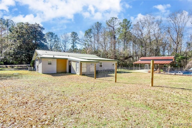 view of outdoor structure with a lawn and central air condition unit