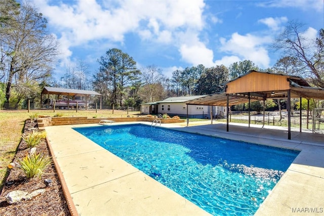 view of swimming pool with a diving board