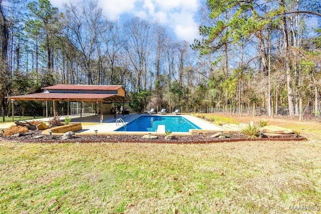 view of swimming pool featuring a yard and a patio