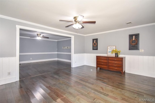 unfurnished room with crown molding, ceiling fan, and dark hardwood / wood-style flooring