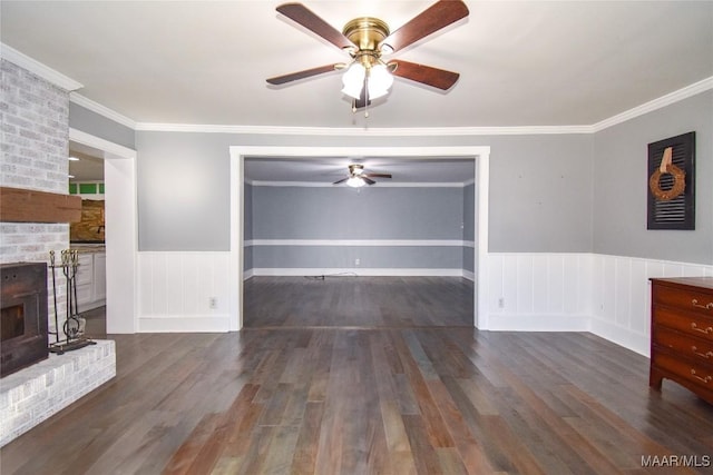 unfurnished living room with a brick fireplace, ornamental molding, dark hardwood / wood-style floors, and ceiling fan