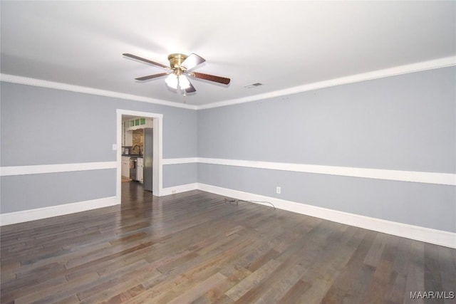 empty room featuring ornamental molding, dark hardwood / wood-style flooring, and ceiling fan