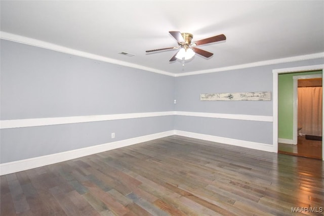 spare room with ornamental molding, dark hardwood / wood-style floors, and ceiling fan