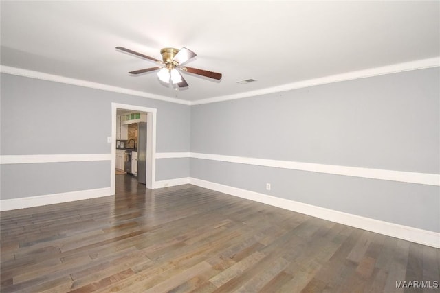 spare room featuring ornamental molding, dark hardwood / wood-style floors, and ceiling fan