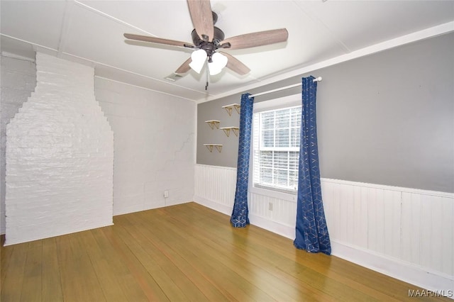 unfurnished room with hardwood / wood-style flooring and ceiling fan