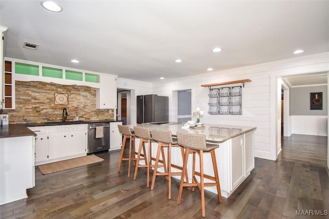 kitchen with white cabinetry, dishwasher, and dark wood-type flooring