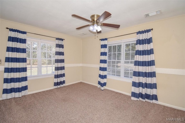 unfurnished room with ceiling fan and carpet flooring