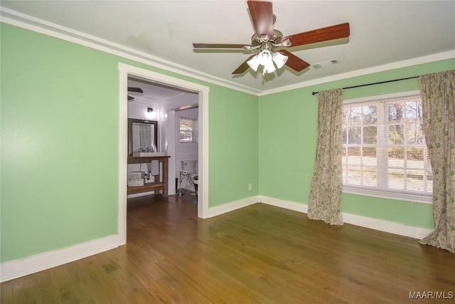 empty room featuring dark wood-type flooring, ceiling fan, and ornamental molding