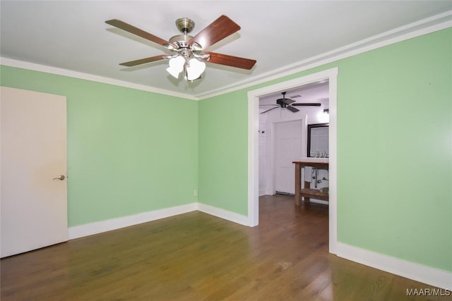 spare room featuring ceiling fan, ornamental molding, and dark hardwood / wood-style floors