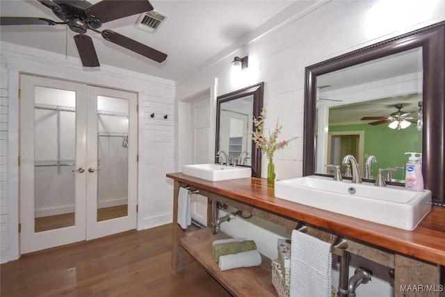 bathroom with sink, hardwood / wood-style flooring, french doors, and ceiling fan