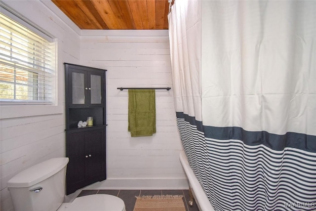 bathroom with wood ceiling, toilet, tile patterned flooring, and wood walls