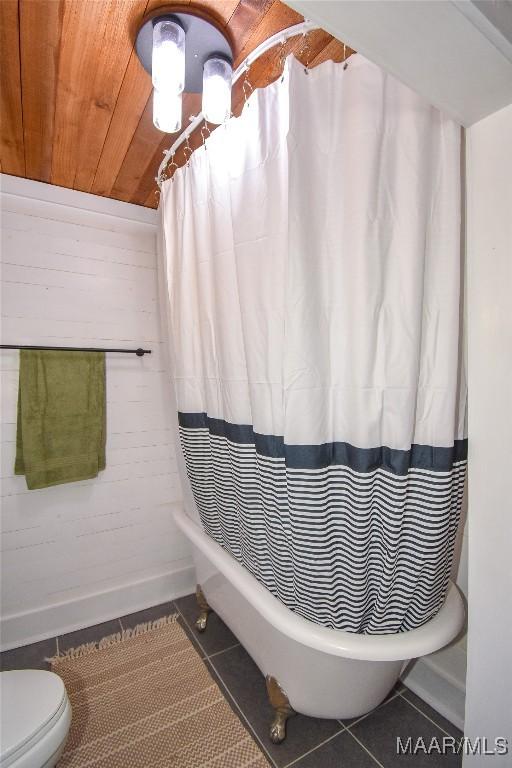 bathroom featuring tile patterned floors, toilet, and wooden ceiling