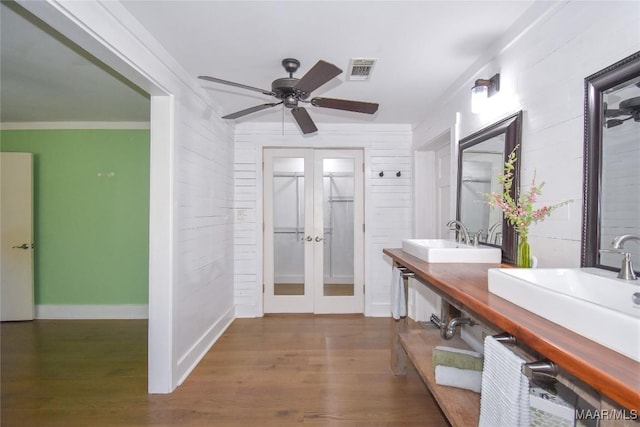 bathroom with hardwood / wood-style flooring, crown molding, ceiling fan, vanity, and french doors