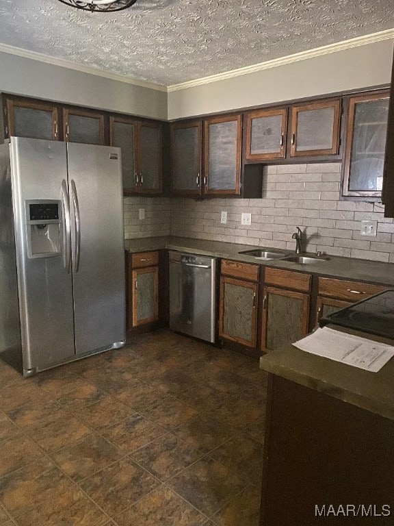 kitchen featuring sink, dark brown cabinets, a textured ceiling, ornamental molding, and stainless steel appliances