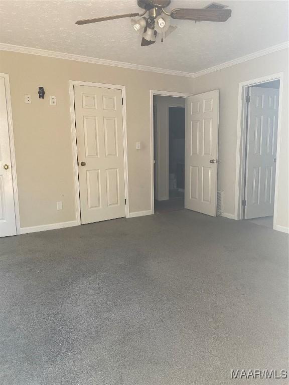 interior space with crown molding, ceiling fan, and a textured ceiling