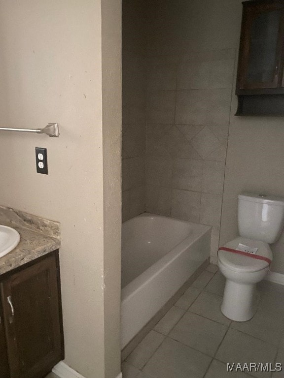 bathroom featuring vanity, a bath, tile patterned floors, and toilet