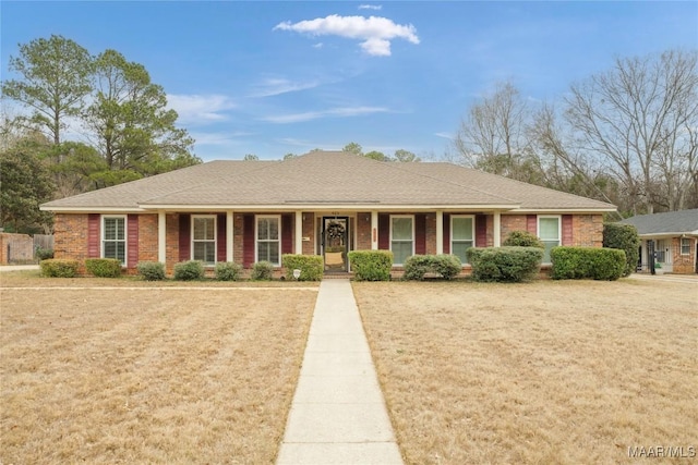 ranch-style home featuring a porch and a front yard